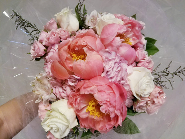 Signature Mother's Day Bouquet - Stunning bouquet of peonies, roses, hydrangeas, filler and greenery wrapped with soft pink tulle fabric.