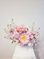 A Mother’s Love Arrangement - A mother’s love is a kind of love no one else will ever supply. Spoil mom with this arrangement of pink, peachy, and creamy flowers like Peonies, roses, spray roses, and stocks.