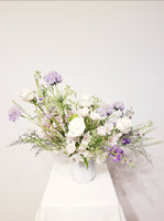 Lavender Bliss - Elegant ceramic vase with lavender Scabiosas, Alstroemeria, roses, Queen Anna Lace, filler, and lush greenery.