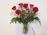 Half Dozen Red Roses and Pink Baby's Breath in Clear Vase