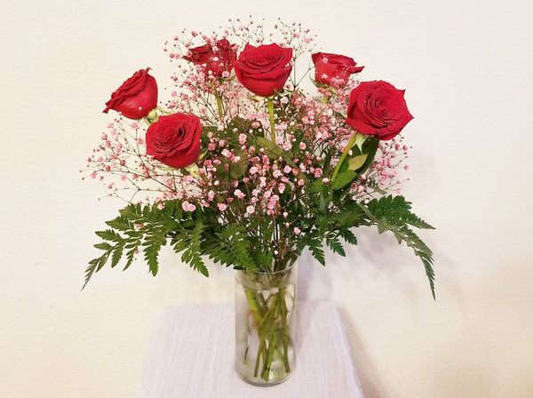 Half Dozen Red Roses and Pink Baby's Breath in Clear Vase