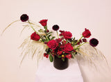 Hanna – Romantic and unique elopement arrangement with gorgeous and fragrant roses, Alstroemerias, Scabiosa, Chrysanthemum Spray and Fresh Pampas Grass and lush greens in black ceramic vase.