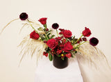 Hanna – Romantic and unique elopement arrangement with gorgeous and fragrant roses, Alstroemerias, Scabiosa, Chrysanthemum Spray and Fresh Pampas Grass and lush greens in black ceramic vase.