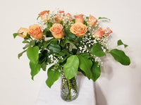 Dozen Orange Roses Arrangement in Clear Vase