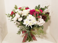 This winter fresh seasonal bouquet of timeless ivory roses, breathtaking white roses, white stocks, Carnations, Mums, Pinecones and seasonal greens and more is sure to wow your lucky loved one.  