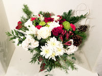 This winter fresh seasonal bouquet of timeless ivory roses, breathtaking white roses, white stocks, Carnations, Mums, Pinecones and seasonal greens and more is sure to wow your lucky loved one.  