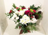 This winter fresh seasonal bouquet of timeless ivory roses, breathtaking white roses, white stocks, Carnations, Mums, Pinecones and seasonal greens and more is sure to wow your lucky loved one.  