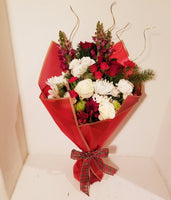 This winter fresh seasonal bouquet of timeless ivory roses, breathtaking white roses, white Snapdragon, Carnations, Mums, and seasonal greens and more is sure to wow your lucky loved one.