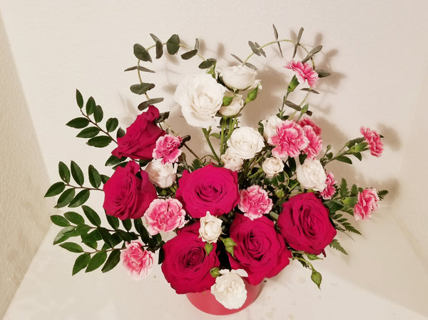 Morden Arrangement design using dozen red and white Roses, filler and greenery. The perfect romantic gift to send to the one who's always on your mind and in your heart!