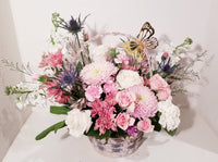 Adorable Valentine basket arrangement, which has a stunning mix of pink, peach, creamy and lavender seasonal flowers such as roses, spray roses, stocks, Mums ...etc,  sophistically arranged with lush greenery and fillers. 