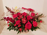 Valentine basket arrangement, which has a stunning mix of roses, spray roses, fancy carnation, spray carnations, Alstroemerias, sophistically arranged with lush greenery and fillers.  