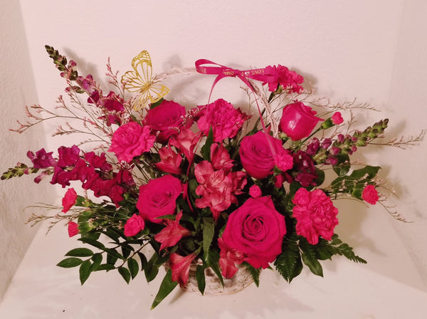 Valentine basket arrangement, which has a stunning mix of roses, spray roses, fancy carnation, spray carnations, Alstroemerias, sophistically arranged with lush greenery and fillers.  