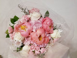 Signature Mother's Day Bouquet - Stunning bouquet of peonies, roses, hydrangeas, filler and greenery wrapped with soft pink tulle fabric.