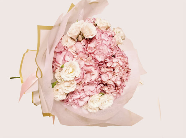 Customizable bouquet with delicate Pink Hydrangeas and White Spray Roses. Pink hydrangeas symbolize love, grace, and thoughtfulness. Perfect for special occasions and heartfelt gestures