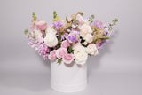 Imagine this gorgeous flower arrangement getting delivered to your door... dreamy! Pink, lavender and creamy flowers such as roses, spray roses, stocks tulips, snapdragons chrysanthemum sophistically arranged with lush greenery and fillers. (Flower: Flowers/Hatbox Color and variety may vary) 