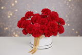 Woman holding a bouquet of red flowers against a blurred background