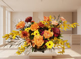 Colorful flower arrangement with yellow, orange, and pink flowers on a light background