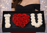 Heart-shaped arrangement of red roses with white roses forming the letters 'I' and 'U' in a black box.