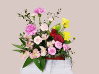 Small mix of seasonal flowers and greenery design in tray. 