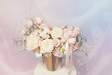 "Pirouette" captures the elegant, spinning movement of a dancer, reflecting the delicate layers and soft colors of the flowers in the arrangement. It suggests grace, beauty, and refined motion.