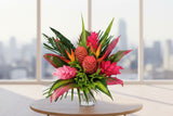 Wild Tropical Passion is a bold, exotic bouquet featuring vibrant tropical blooms and lush greenery.