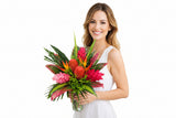 Wild Tropical Passion is a bold, exotic bouquet featuring vibrant tropical blooms and lush greenery.