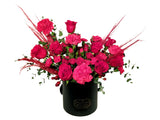 hatbox arrangement of red roses and carnations