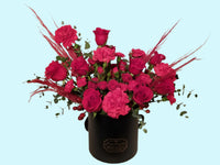 hatbox arrangement of red roses and carnations