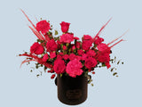 hatbox arrangement of red roses and carnations