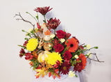 beautiful arrangement filled with roses, Chrysanthemums, and mums in the warm hues of fall