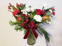 Winter Fresh Cut Mixed Floral Arrangement in Clear Vase An array of winter fresh cut flowers of the holiday arranged in clear vases.
