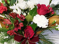 Winter Fresh Cut Mixed Floral Arrangement in Clear Vase An array of winter fresh cut flowers of the holiday arranged in clear vases.