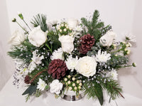 Our designers will create a custom arrangement using our best and White/Ivory & Silver Or White/Ivory & Gold flowers for holiday.