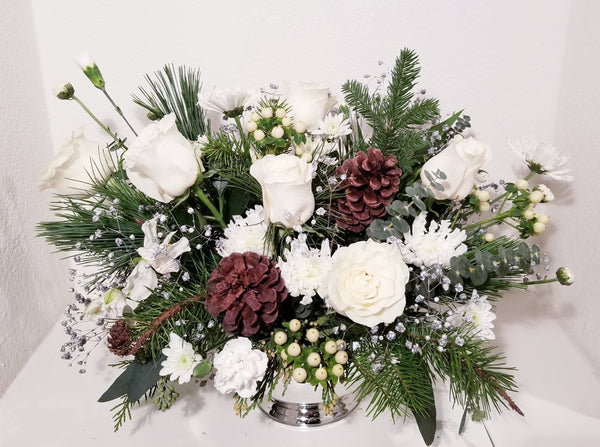 Our designers will create a custom arrangement using our best and White/Ivory & Silver Or White/Ivory & Gold flowers for holiday.