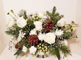 Our designers will create a custom arrangement using our best and White/Ivory & Silver Or White/Ivory & Gold flowers for holiday.