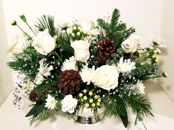 Our designers will create a custom arrangement using our best and White/Ivory & Silver Or White/Ivory & Gold flowers for holiday.