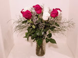 This cheerful design arranged with dozen of red and white roses and fillers, and accented with assorted with greens in clear vase. 